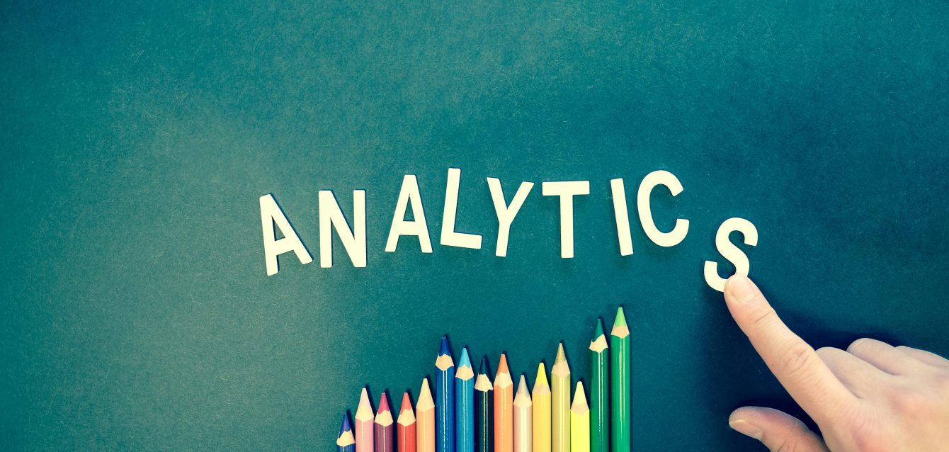 Analytics dashboard and colored pencils symbolizing data-driven creativity for boosting email open rates and CTR.
