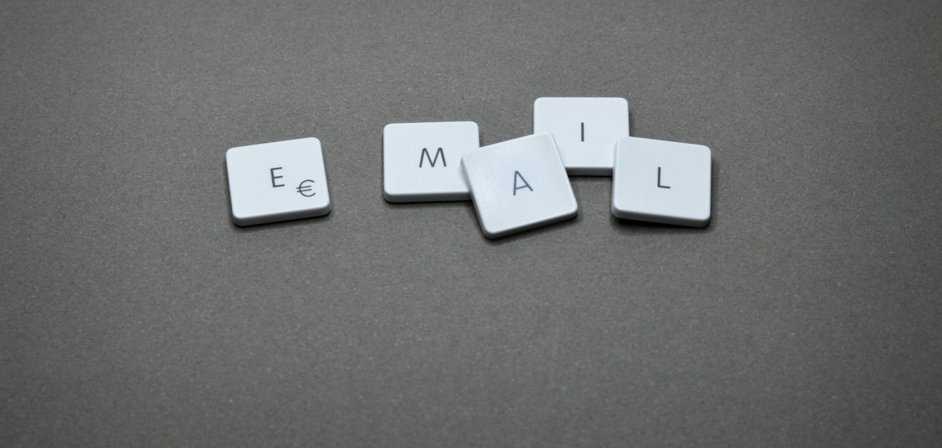 Scrabble tiles spelling ‘email’ symbolizing creative copywriting and cognitive triggers in email engagement.