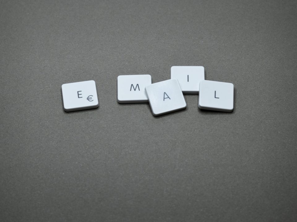 Scrabble tiles spelling ‘email’ symbolizing creative copywriting and cognitive triggers in email engagement.
